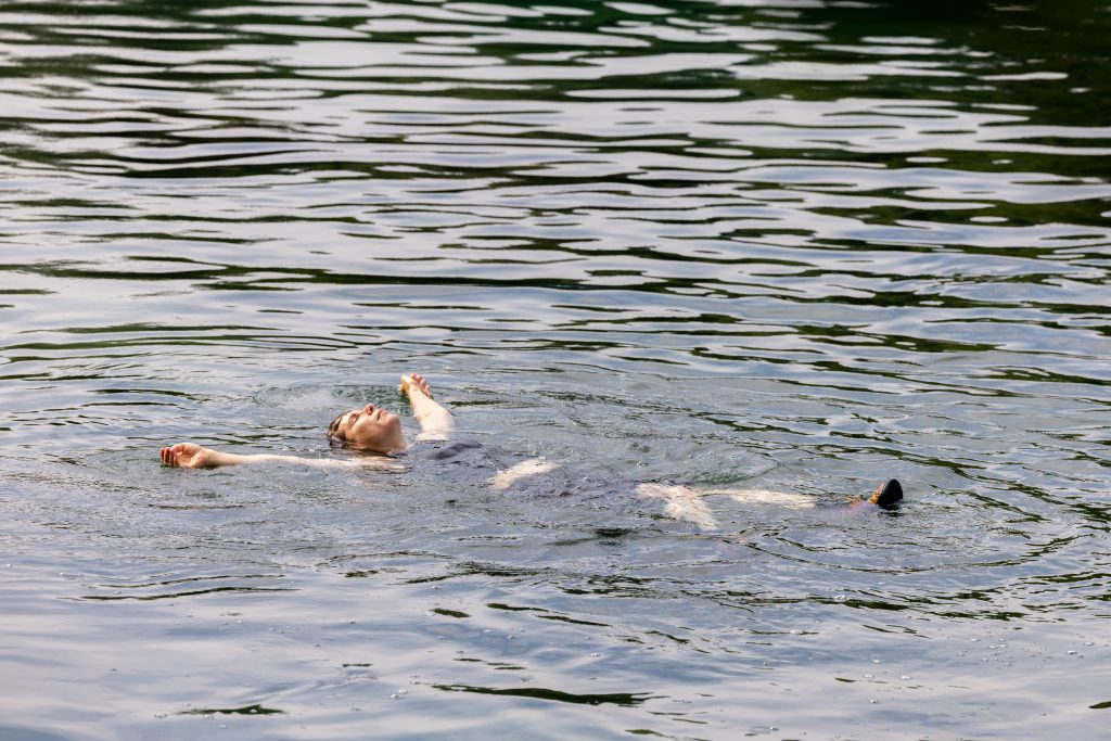 A person floating in the rhine, relaxed